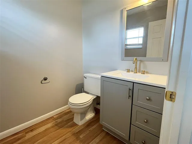 a bathroom with a sink toilet and mirror