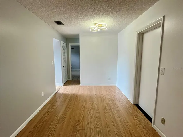 a view of a room with wooden floor and brick walls