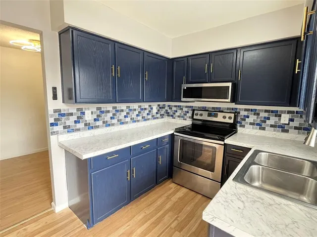 a kitchen with a sink stove and microwave