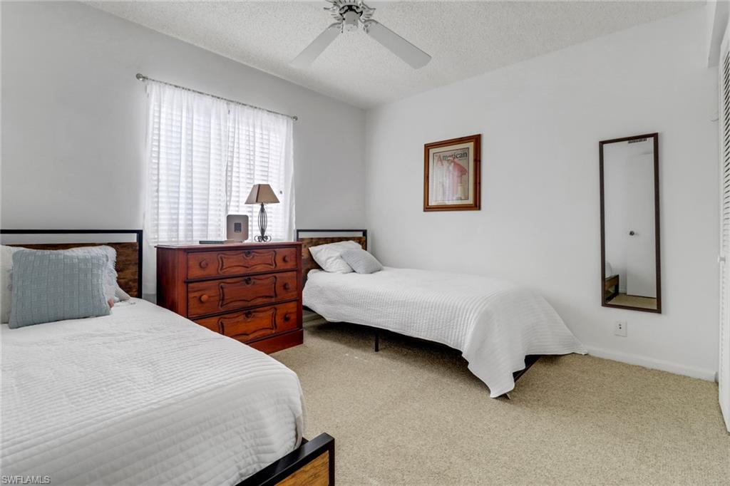 7791 Esmeralda Way, Unit L103 Naples, FL 34109 - Photo 17 of 46 a bedroom with bed and window