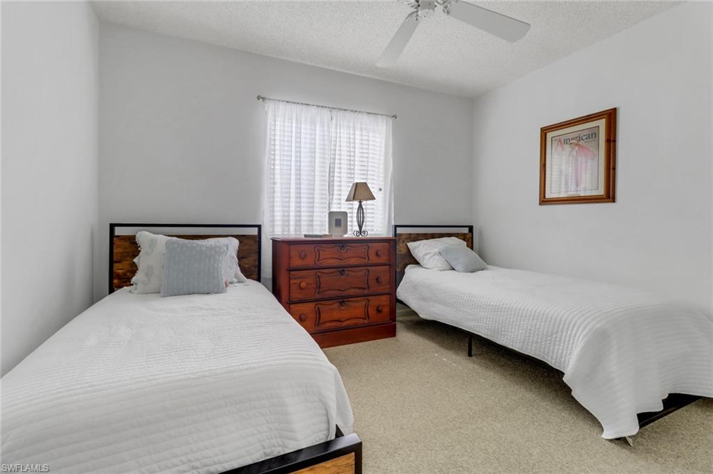 7791 Esmeralda Way, Unit L103 Naples, FL 34109 - Photo 19 of 46 a bedroom with bed and window