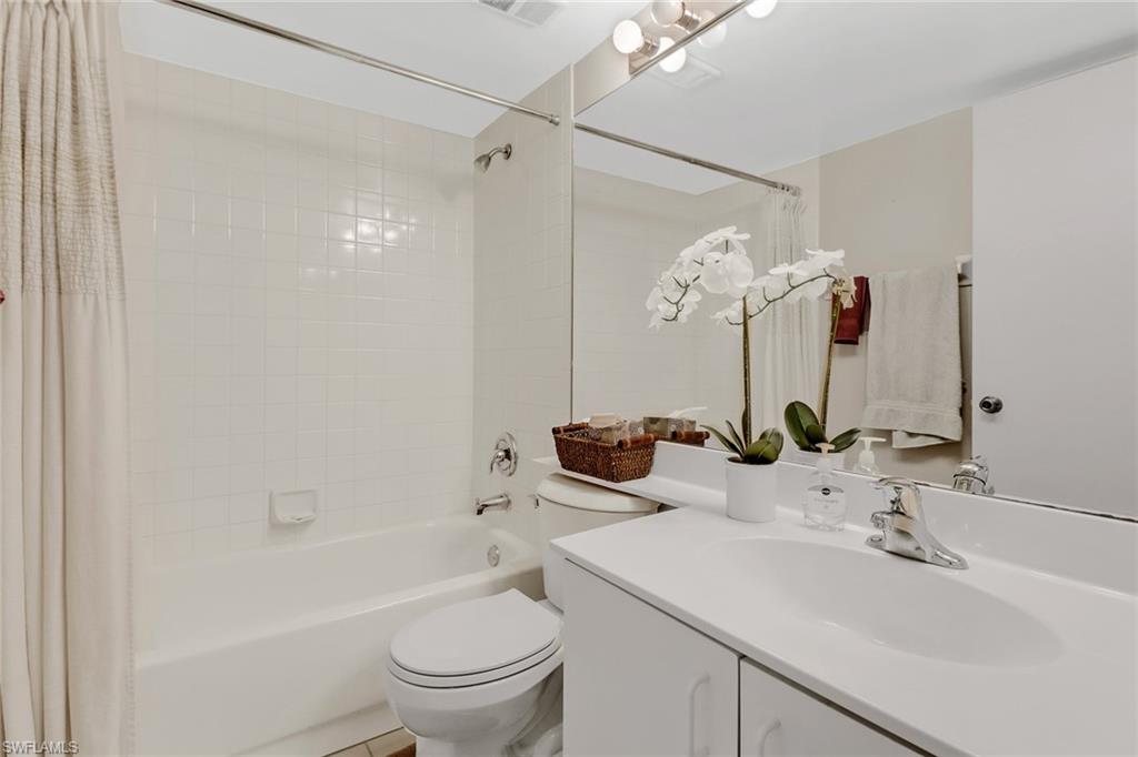 7791 Esmeralda Way, Unit L103 Naples, FL 34109 - Photo 20 of 46 a bathroom with a sink a toilet and shower