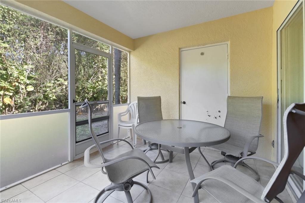 7791 Esmeralda Way, Unit L103 Naples, FL 34109 - Photo 21 of 46 a view of a dining room with furniture and a window