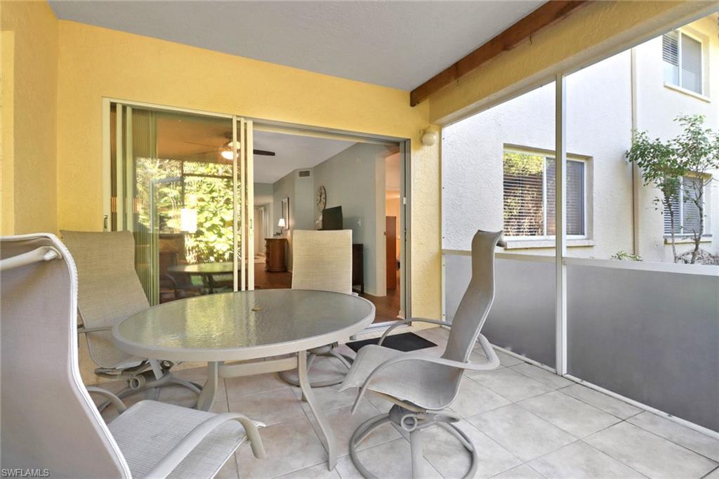 7791 Esmeralda Way, Unit L103 Naples, FL 34109 - Photo 22 of 46 a dining room with table and chairs