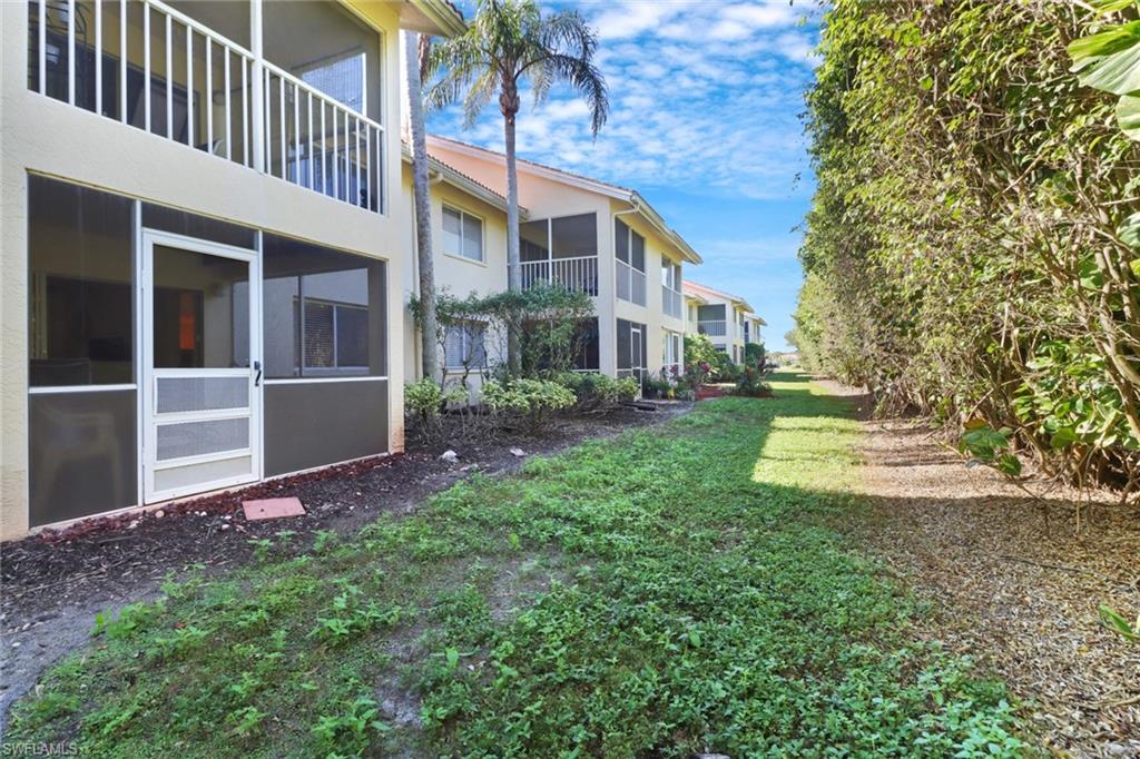 7791 Esmeralda Way, Unit L103 Naples, FL 34109 - Photo 23 of 46 a view of a house with a yard and pathway