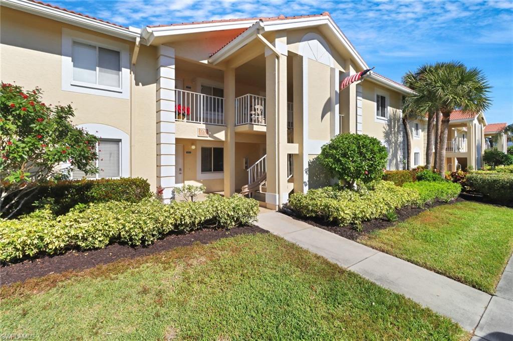 7791 Esmeralda Way, Unit L103 Naples, FL 34109 - Photo 30 of 46 a front view of a house with garden