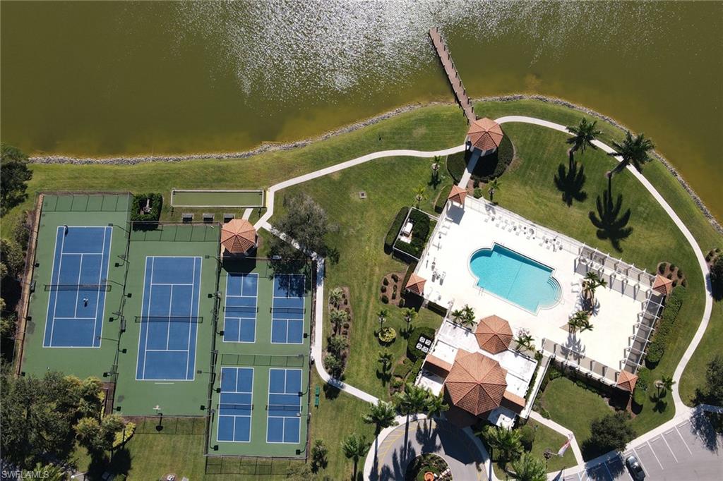 7791 Esmeralda Way, Unit L103 Naples, FL 34109 - Photo 32 of 46 an aerial view of a house with a yard and fountain in front of it