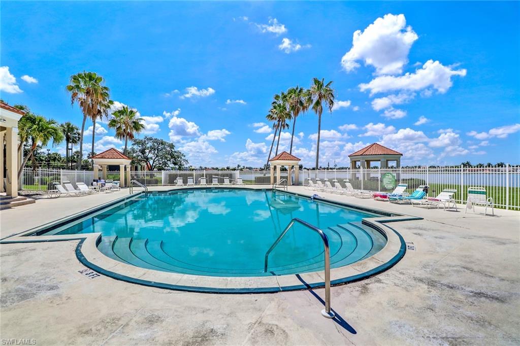 7791 Esmeralda Way, Unit L103 Naples, FL 34109 - Photo 35 of 46 a view of a swimming pool with outdoor seating