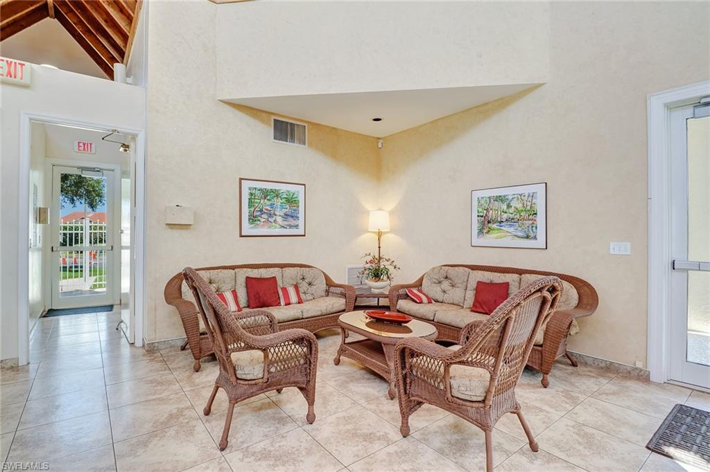 7791 Esmeralda Way, Unit L103 Naples, FL 34109 - Photo 36 of 46 a living room with furniture and a window