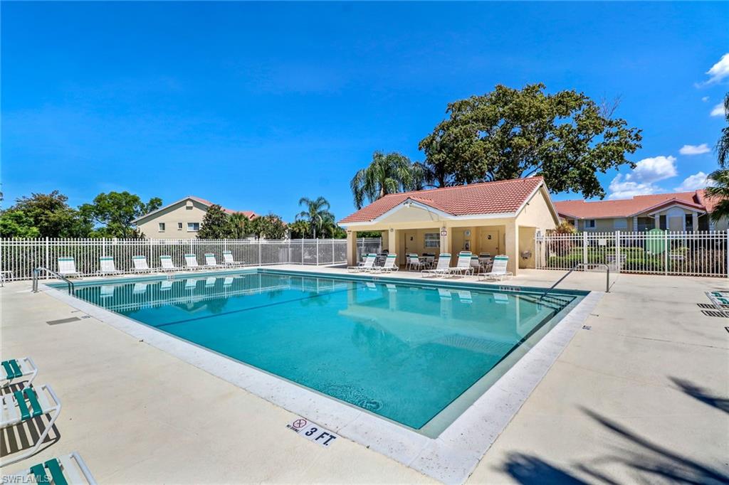 7791 Esmeralda Way, Unit L103 Naples, FL 34109 - Photo 39 of 46 a view of swimming pool with outdoor seating and yard