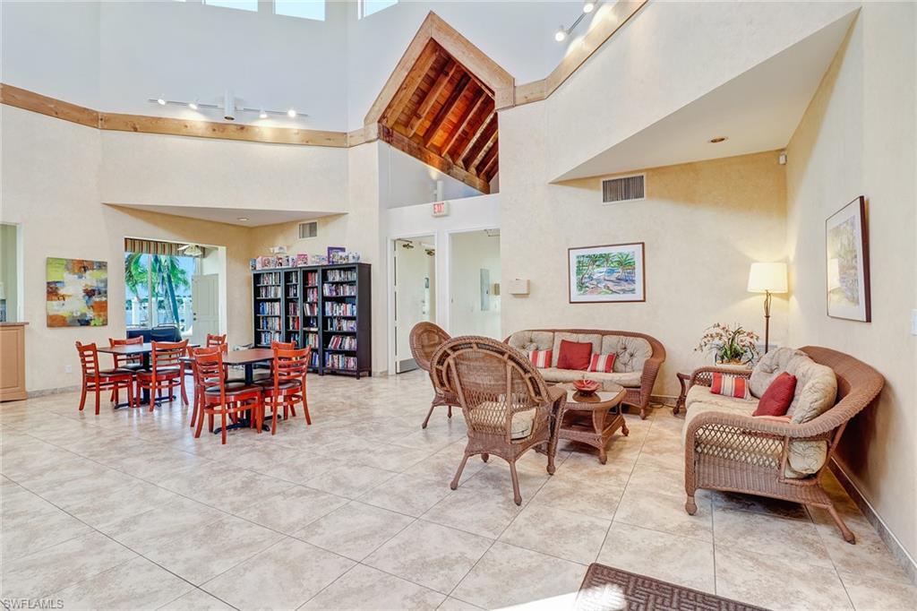 7791 Esmeralda Way, Unit L103 Naples, FL 34109 - Photo 42 of 46 a living room with furniture and a large window