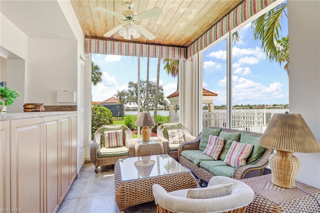 7791 Esmeralda Way, Unit L103 Naples, FL 34109 - Photo 44 of 46 a living room with furniture and a large window