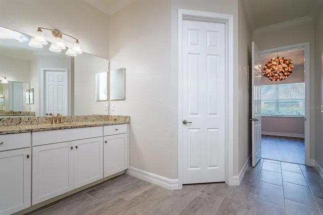 a bathroom with a granite countertop sink a mirror and a shower