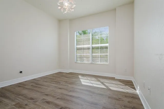 a view of wooden floor and windows in a room