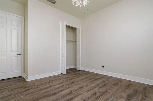 a view of room with wooden floor