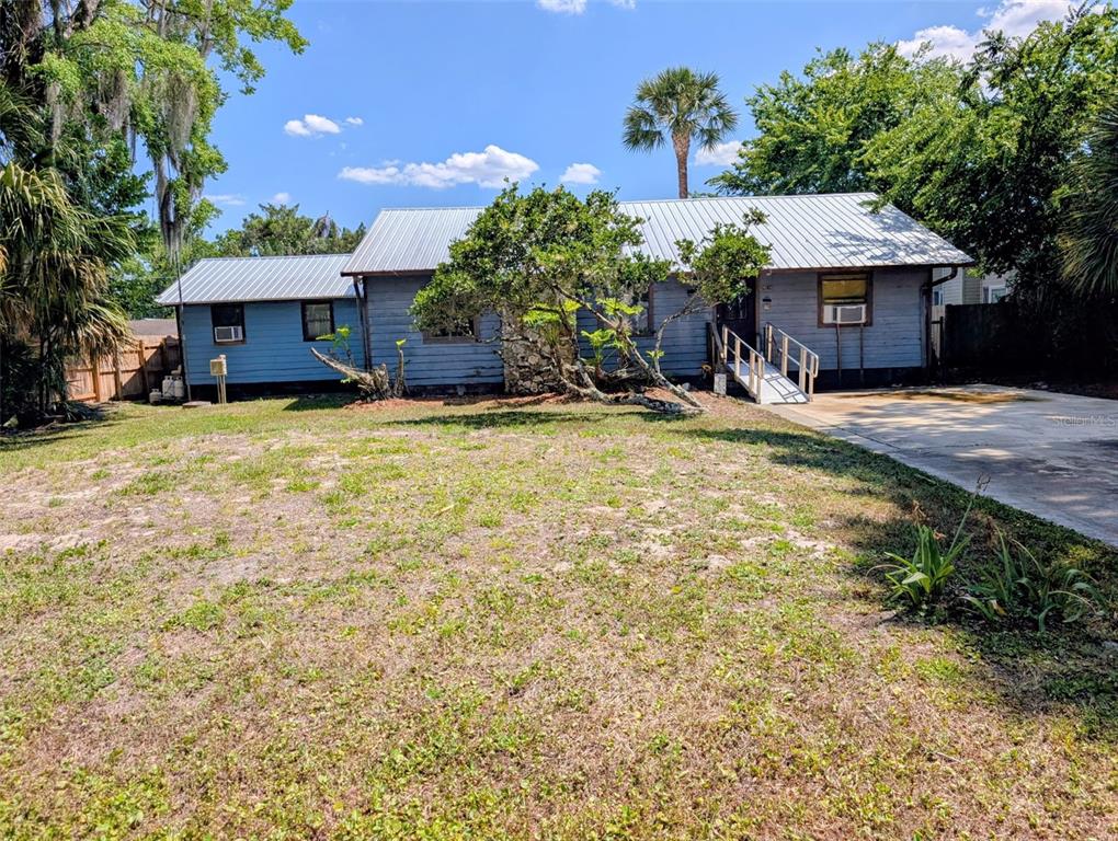 24514 Bonnet Road Astor, FL 32102 - Photo 1 of 37 a front view of a house with a yard