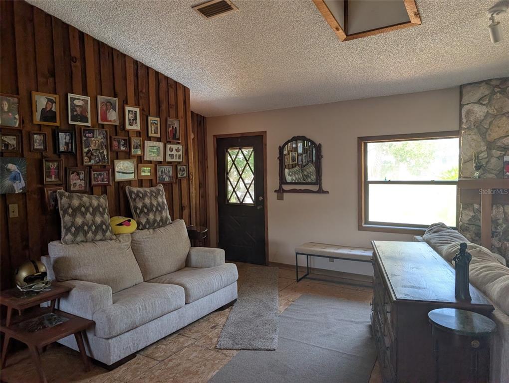 24514 Bonnet Road Astor, FL 32102 - Photo 16 of 37 a living room with furniture and a window