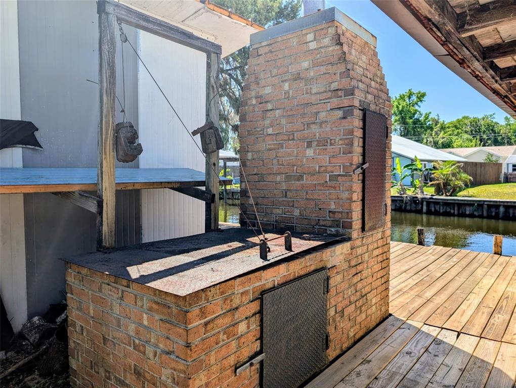 24514 Bonnet Road Astor, FL 32102 - Photo 4 of 37 a terrace with wooden floor barbeque oven and yard in the back