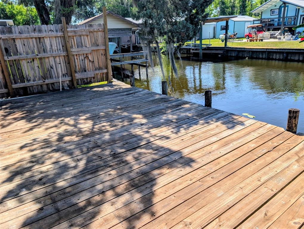 24514 Bonnet Road Astor, FL 32102 - Photo 9 of 37 a view of a house with wooden floor and lake view