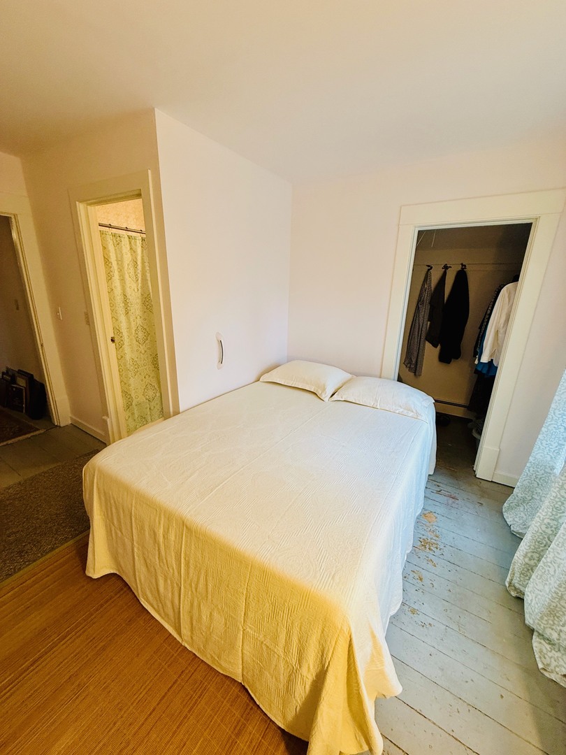 742 South 4th Street DeKalb, IL 60115 - Photo 26 of 46 a bed sitting in a bedroom next to a window