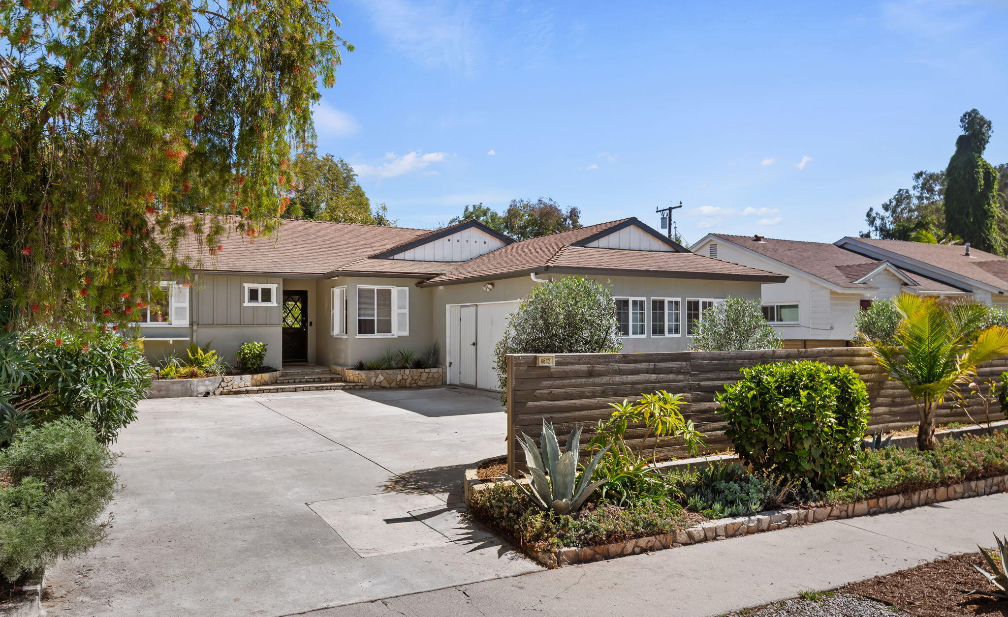 a front view of a house with a garden