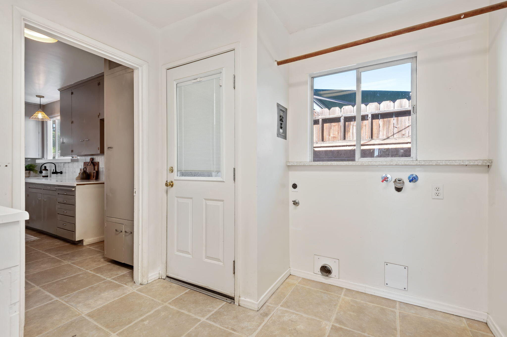 4612 Dean Drive Ventura, CA 93003 - Photo 11 of 33 a view of a kitchen with white cabinets and a window