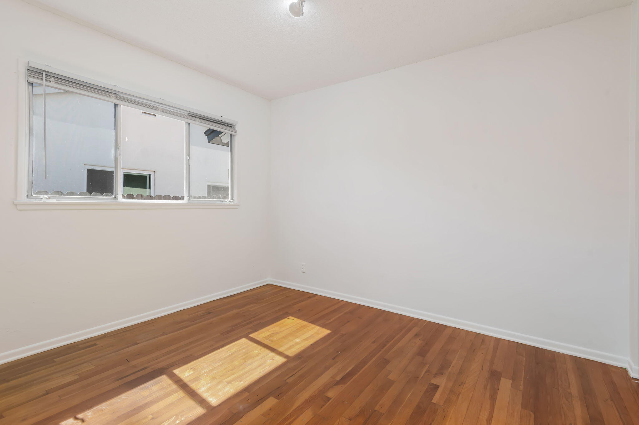 4612 Dean Drive Ventura, CA 93003 - Photo 22 of 33 a view of a room with wooden floor and a window