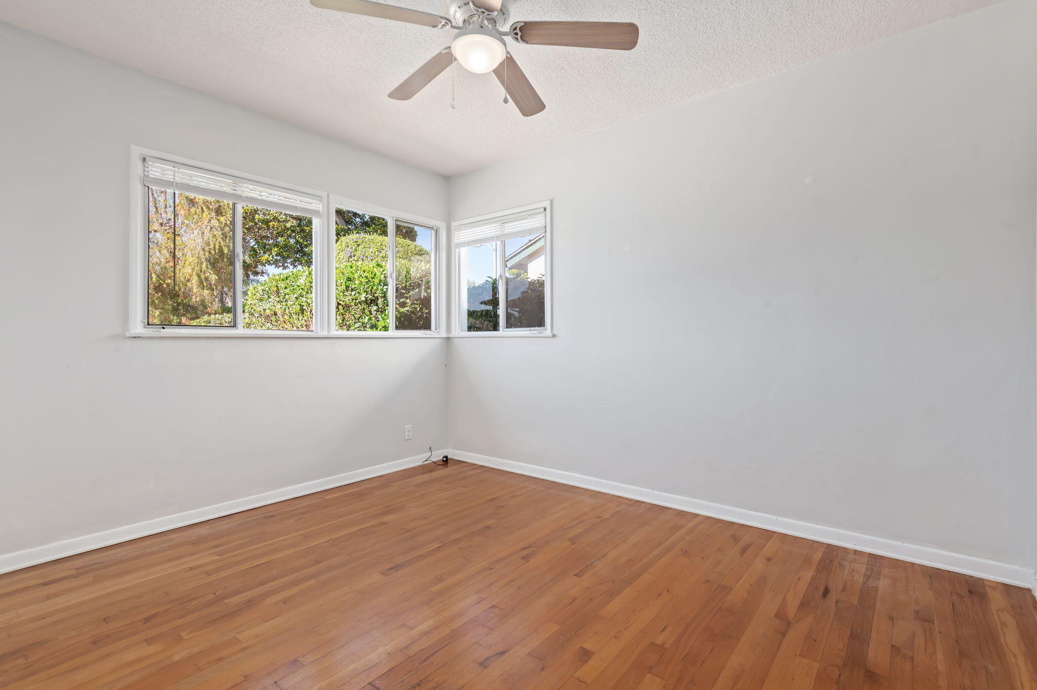 4612 Dean Drive Ventura, CA 93003 - Photo 25 of 33 a view of an empty room with wooden floor and a window