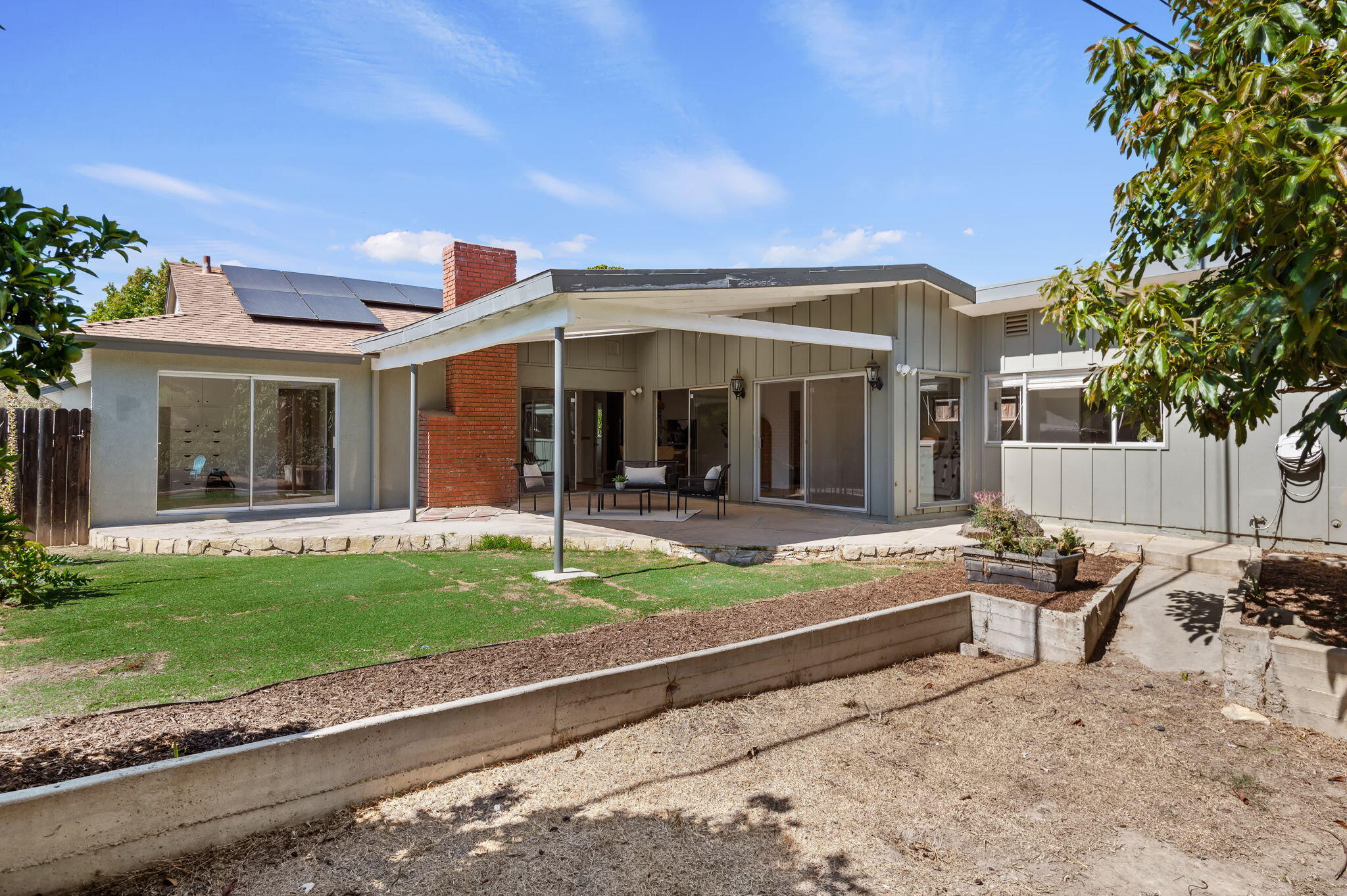 4612 Dean Drive Ventura, CA 93003 - Photo 30 of 33 a view of a chair and tables in the patio yard