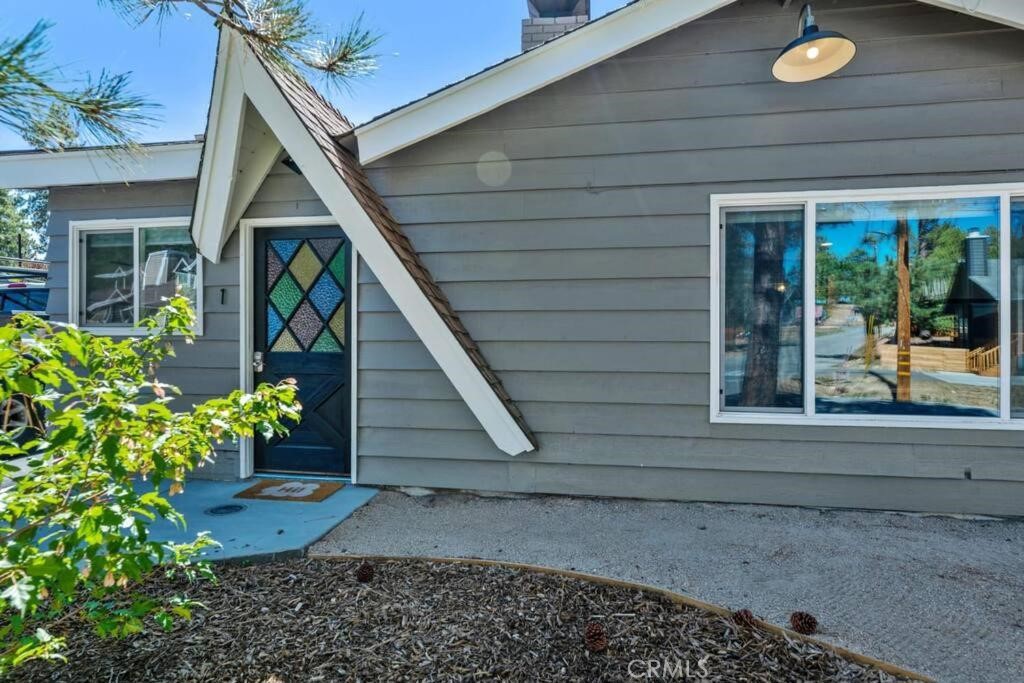 560 Edgemoor Road, Unit 1 Big Bear Lake, CA 92315 - Photo 2 of 10 a front view of a house with a yard