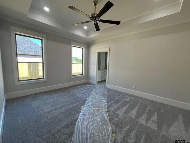 a view of a livingroom with a ceiling fan and window