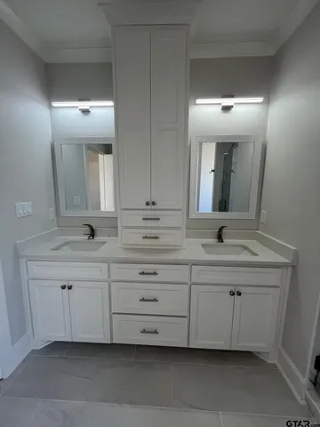 a bathroom with a double vanity sink and mirror