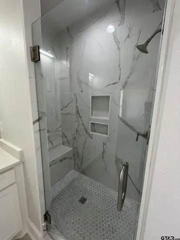 a bathroom with a shower and toilet