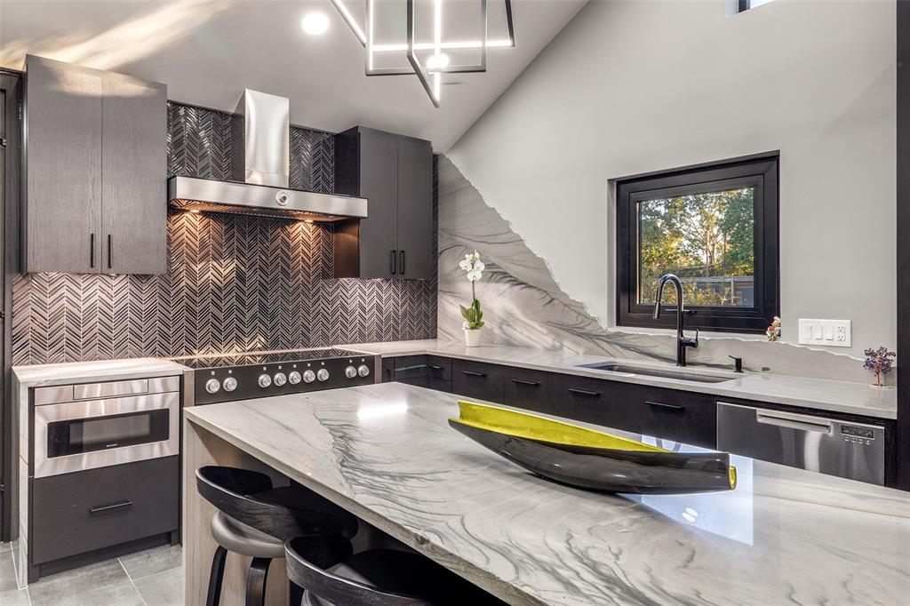 6566 Ridgeview Circle Dallas, TX 75240 - Photo 13 of 39 a kitchen with a sink a stove and chairs
