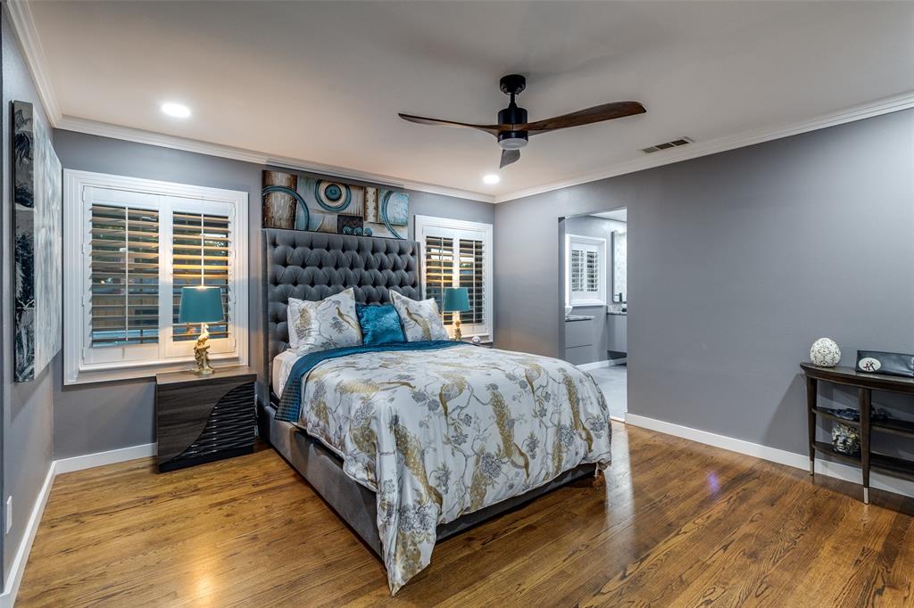 6566 Ridgeview Circle Dallas, TX 75240 - Photo 22 of 39 a bedroom with a large bed and a chandelier