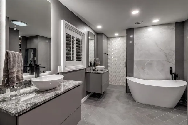 a bathroom with a bathtub and shower
