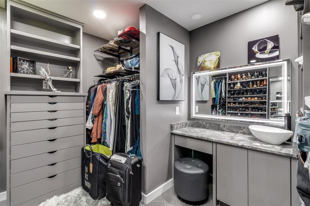 6566 Ridgeview Circle Dallas, TX 75240 - Photo 25 of 39 a view of walk in closet with clothes and shoes