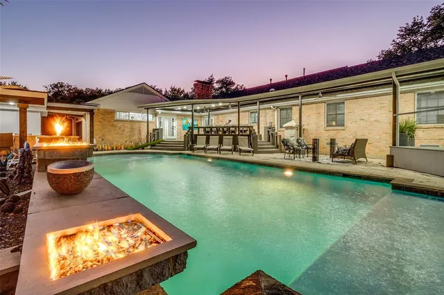 a view of swimming pool with seating area