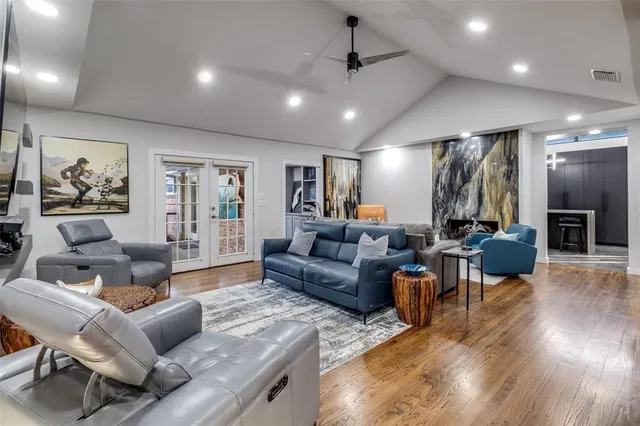 a large kitchen with stainless steel appliances kitchen island granite countertop a refrigerator and a sink