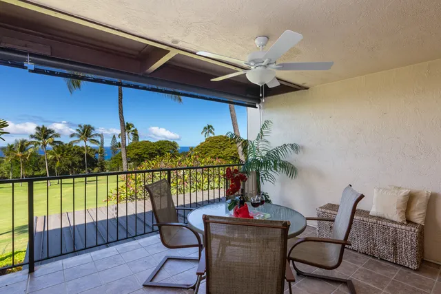a view of a chairs and table in the balcony