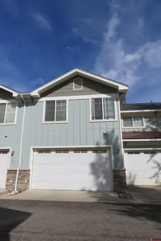 a front view of a house with parking space