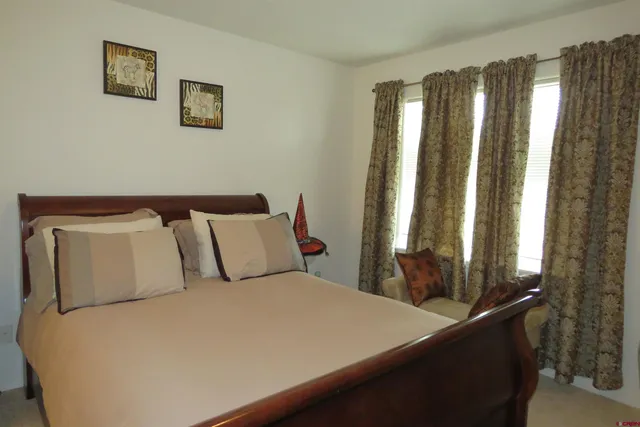 a bed sitting in a bedroom next to a window