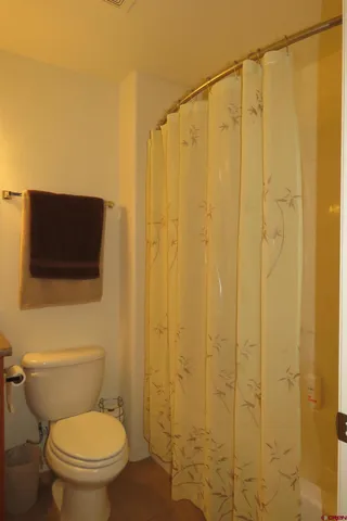 a bathroom with a toilet a sink and shower