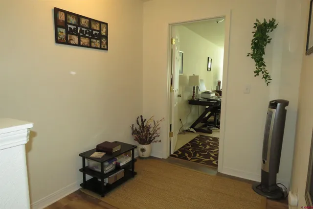 a view of a livingroom with wooden floor and staircase