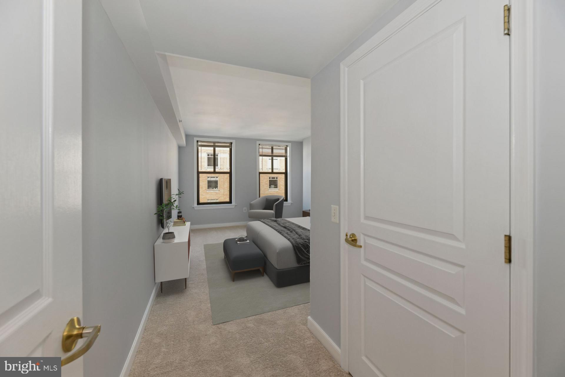 616 E Street Northwest, Unit 1020 Washington, DC 20004 - Photo 9 of 23 a bedroom with a bed and wooden floor