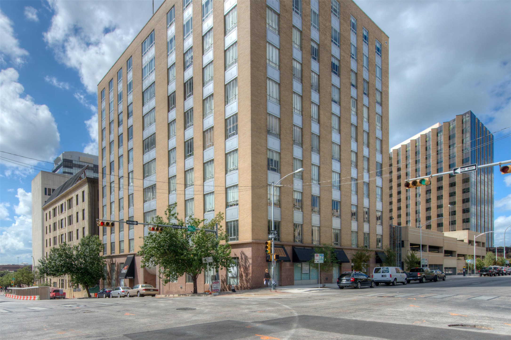710 Colorado Street, Unit 6E Austin, TX 78701 - Photo 24 of 24 A prominent urban high-rise with numerous windows anchors this lively city corner.