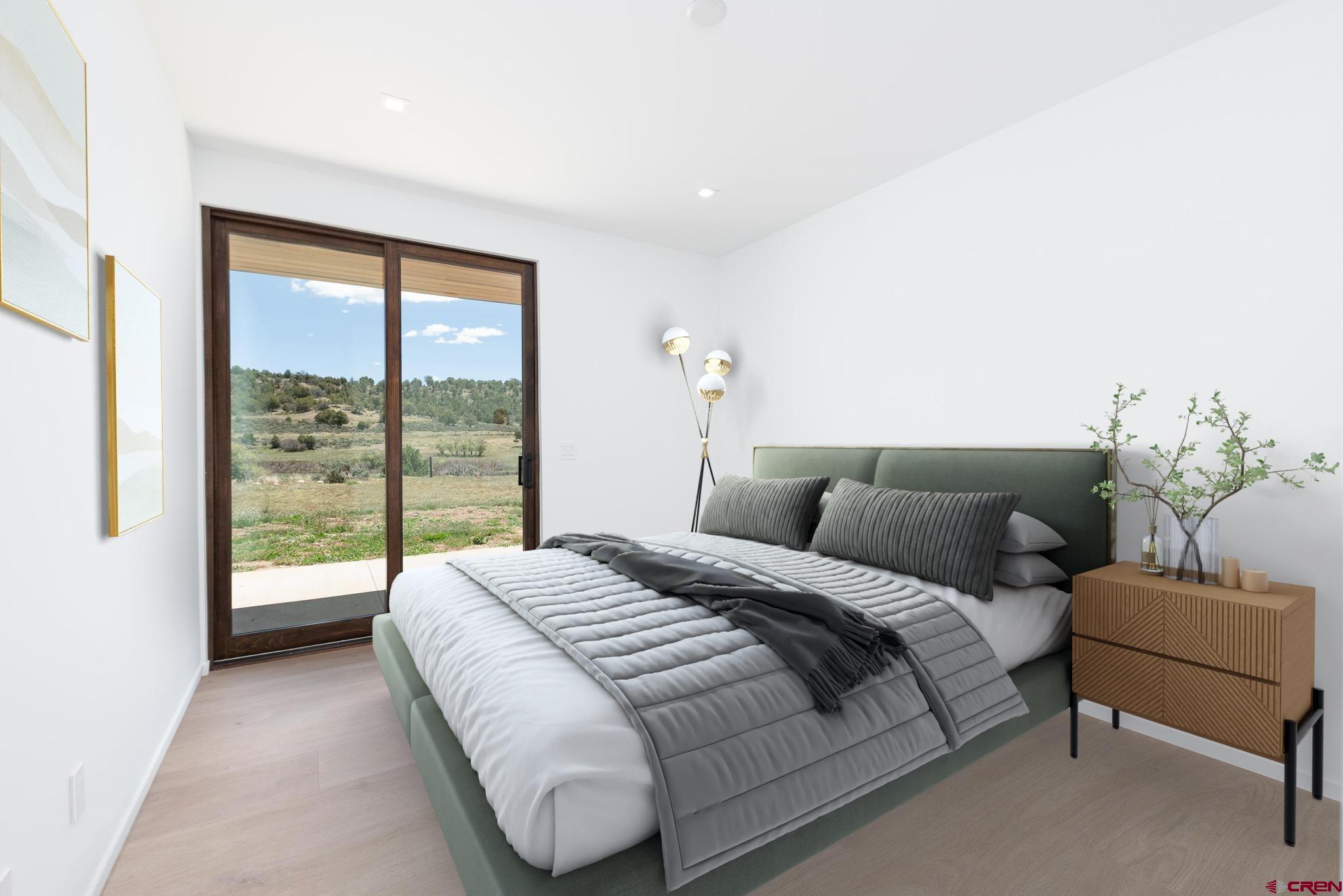 201 Cowboy Trail Durango, CO 81303 - Photo 22 of 45 a bedroom with a bed and a large window