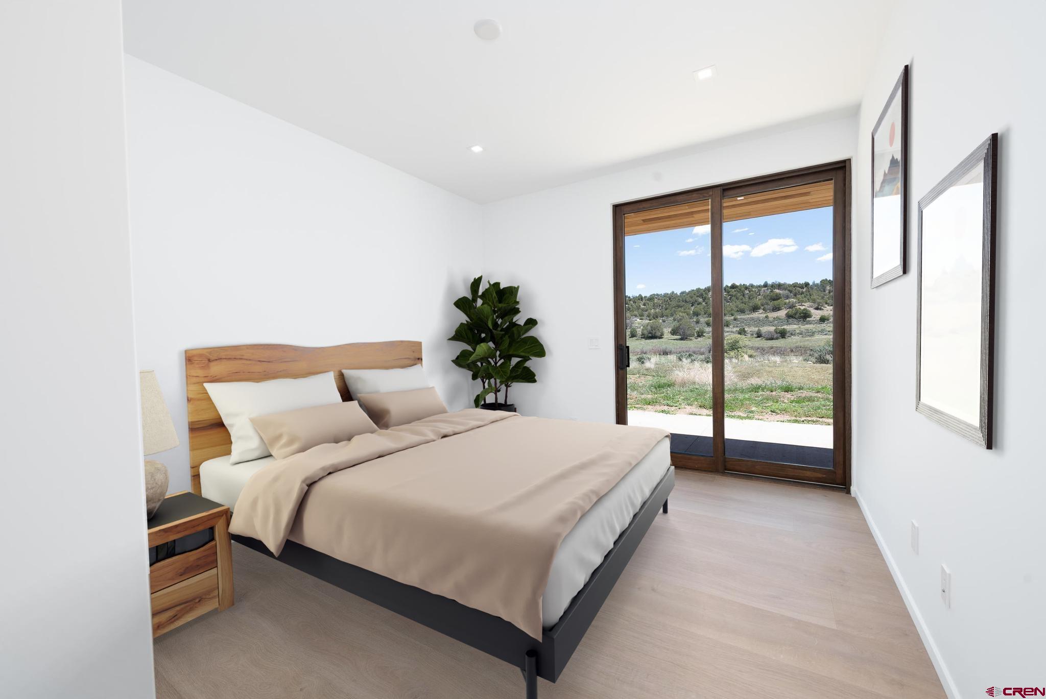 201 Cowboy Trail Durango, CO 81303 - Photo 24 of 45 a bedroom with a large bed and a large window