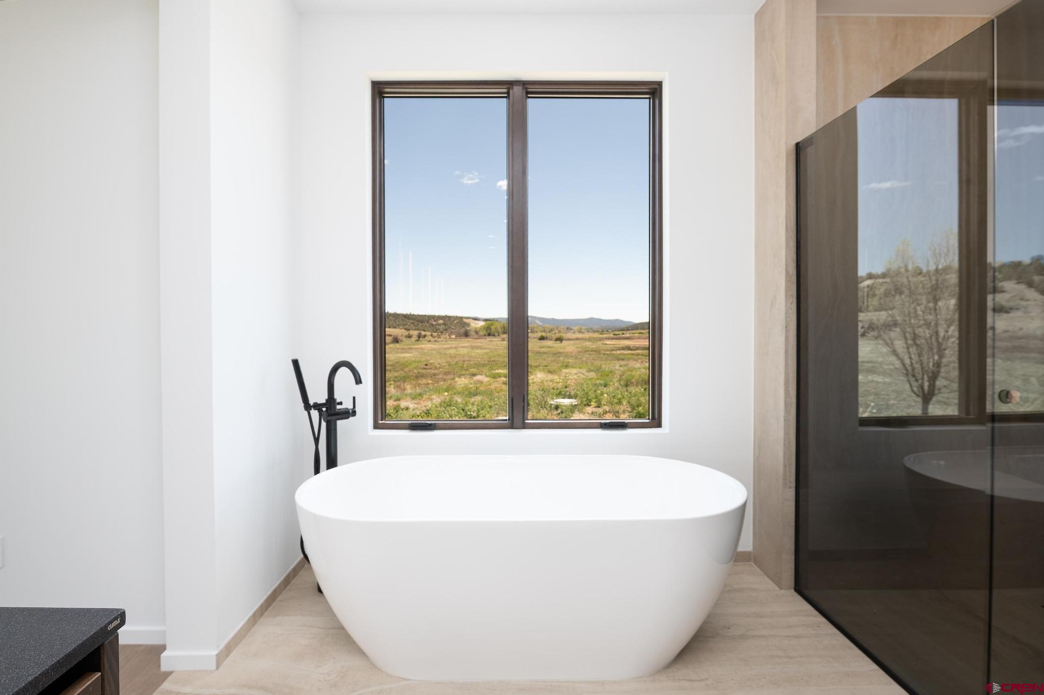 201 Cowboy Trail Durango, CO 81303 - Photo 31 of 45 a white bath tub sitting next to a window