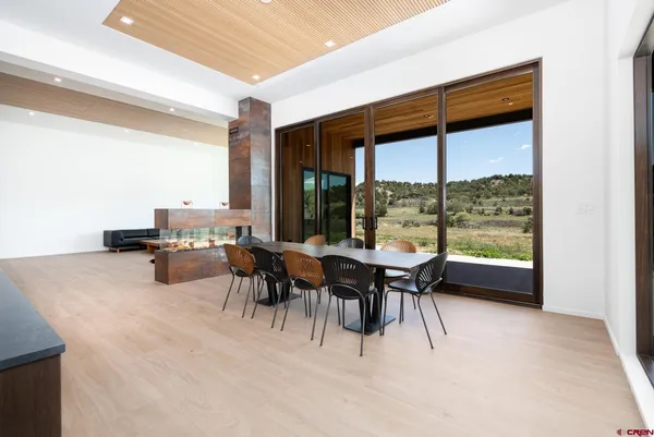 a living room with stainless steel appliances kitchen island granite countertop a sink and a granite counter tops with a large window